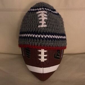 Homemade small child’s football knitted hat